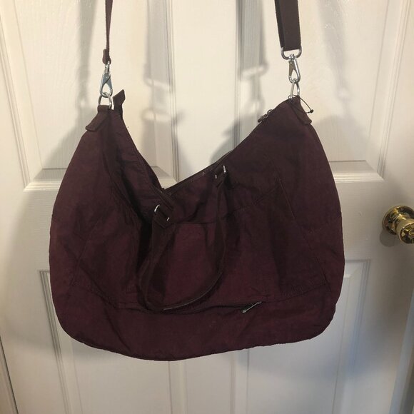 Kipling purple travel bag, handles and shoulder strap